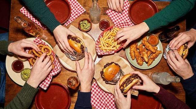 A full table: burgers, fries, onion rings